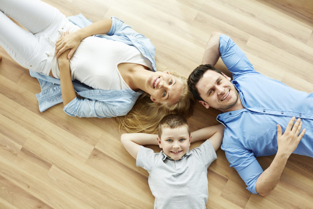 Family relaxing on a heated basement floor