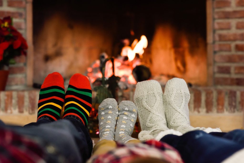 Family in front of a fireplace