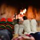 Family in front of a fireplace