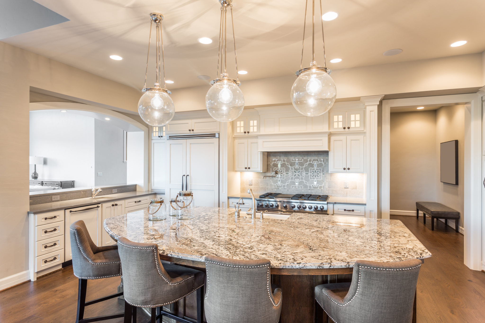 Kitchen with Island, Sink, Cabinets, and Hardwood Floors