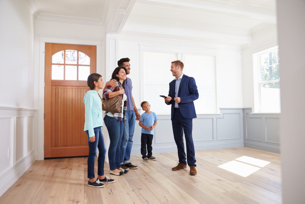 Realtor Showing Family Around New Home