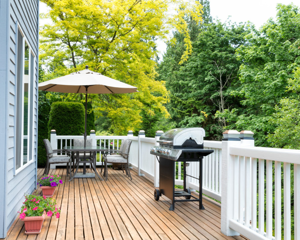 Wood deck with a grill and table