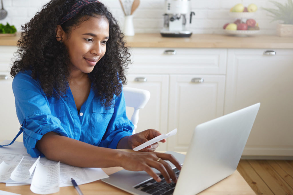 Young woman paying bills