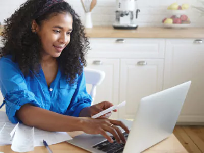 Young woman paying bills