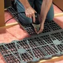 Woman installing AtticDek floor storage panels