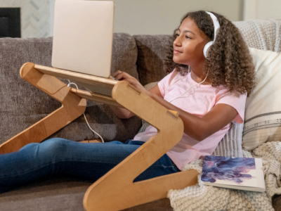 Teenager using a laptop stand