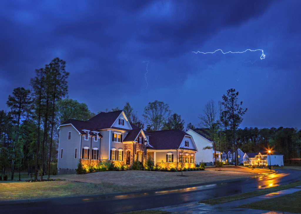 Powerful lightning storm front passes over residential houses