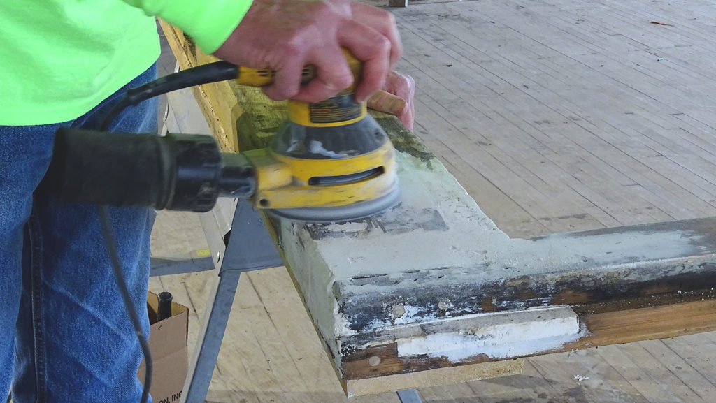 Sanding WoodEpox on a door frame.