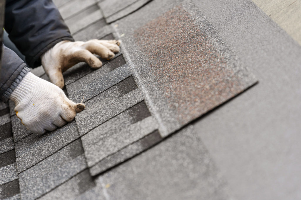 Roof shingle being installed