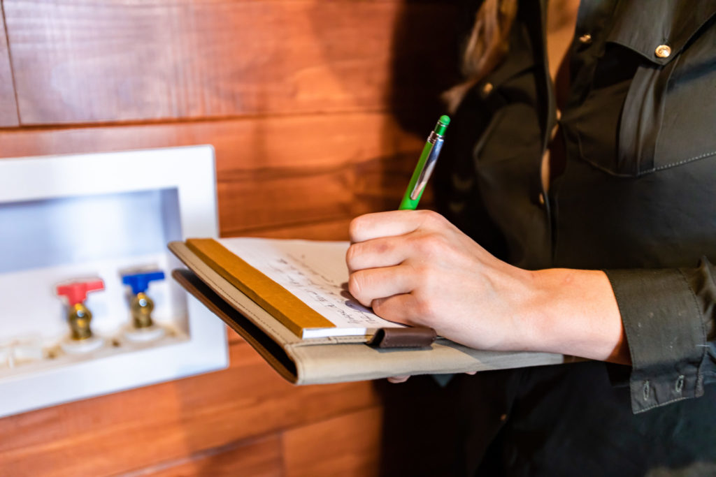 Woman holding a clipboard doing a home appraisal