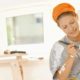 Young woman painting wall at home