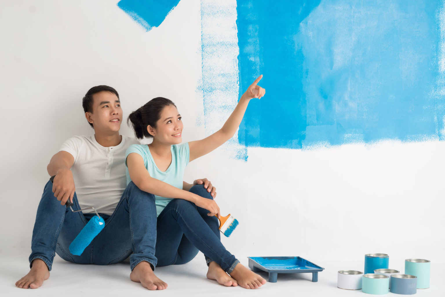 First-time homeowners take a break from a painting project