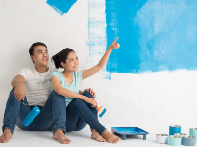 First-time homeowners take a break from a painting project