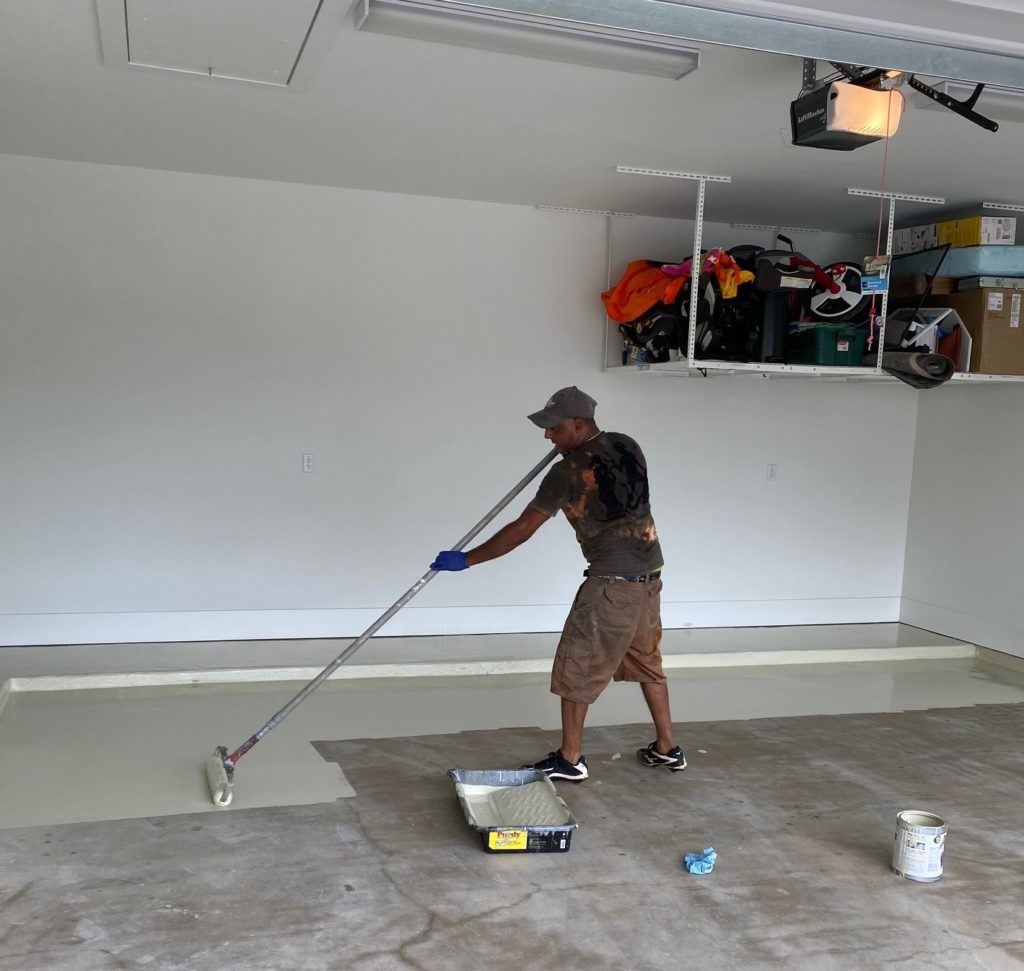 Garage floor being painted using DaiHard® 100 epoxy coating