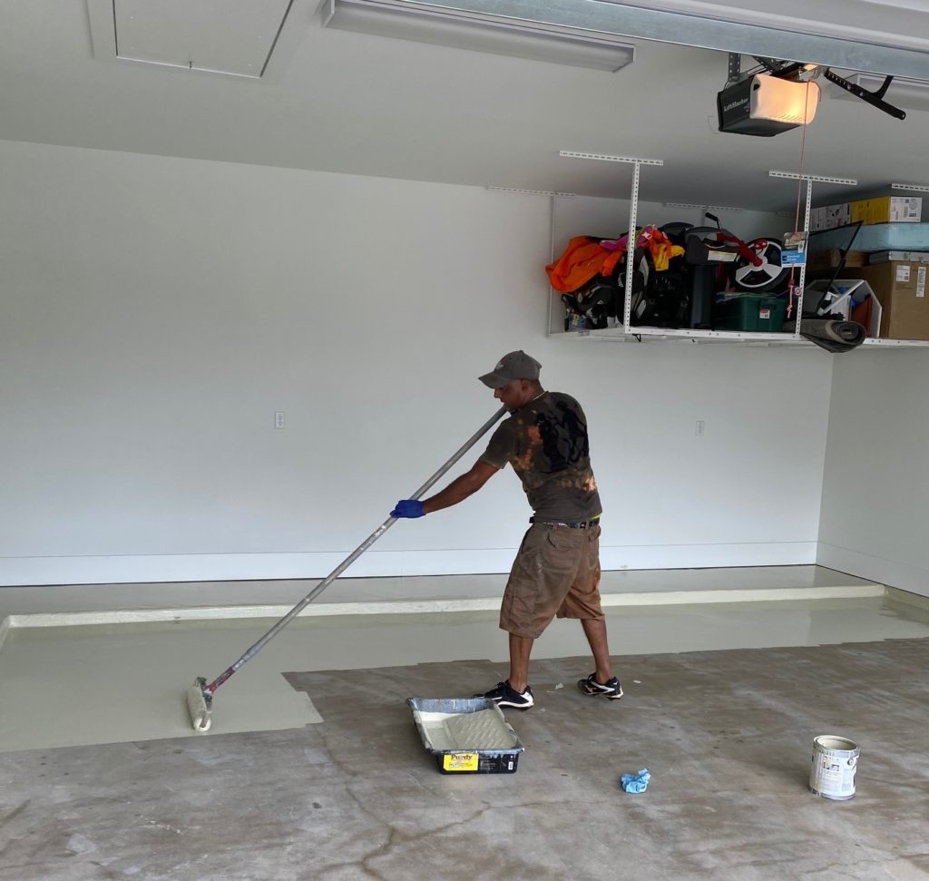 Garage floor being painted using DaiHard® 100 epoxy coating