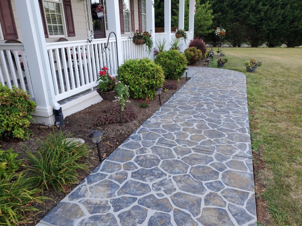 This front walkway was finished using SpreadStone™ Decorative Concrete Resurfacing Kit and a Flagstone Stencil Kit from Daich Coatings.