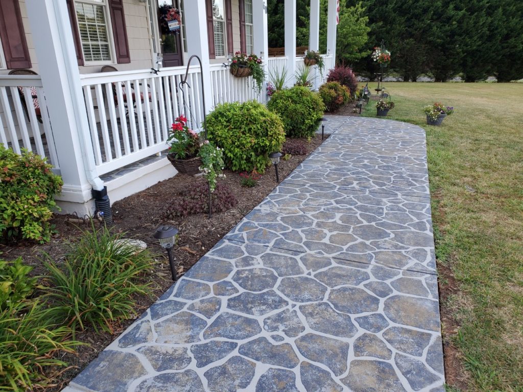 This front walkway was finished using SpreadStone™ Decorative Concrete Resurfacing Kit and a Flagstone Stencil Kit from Daich Coatings.