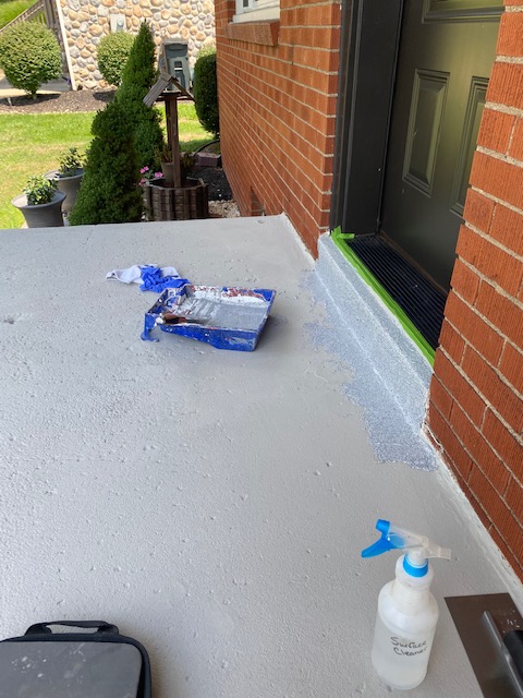 Front porch and steps coated with Daich Coatings SpreadRock® granite stone coating in a Flint Gray color. Then with TracSafe® Anti-Slip Sealer