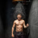 Man with bucket of ice cold water after hot sauna