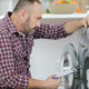 Repairman looking at washing machine