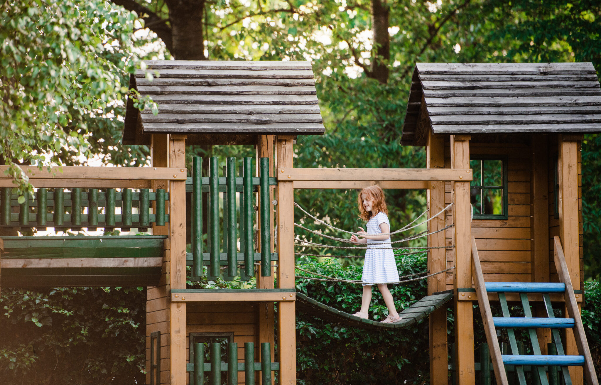 Child on wood play house above ground