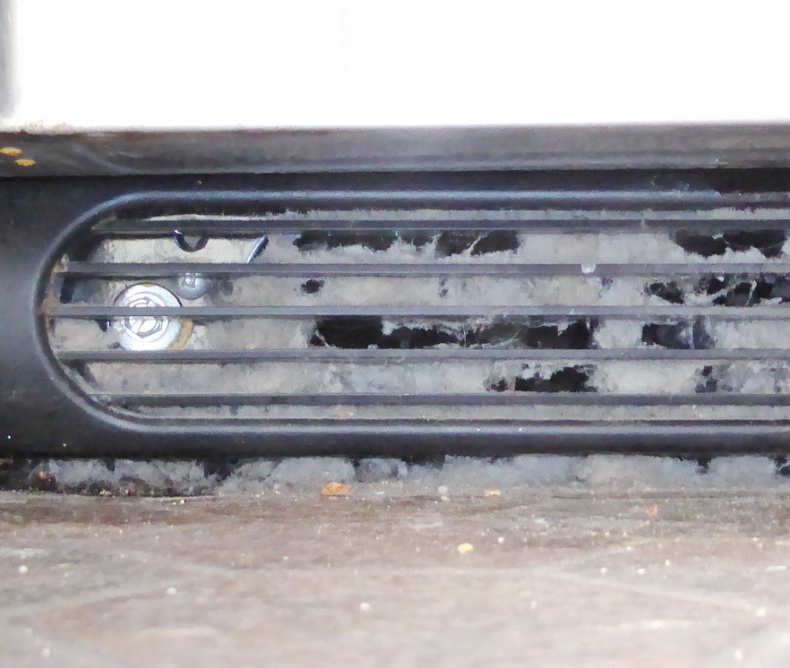 Dusty refrigerator grill containing pet and mold allergens