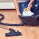 Changing a full dust bag from a vacuum cleaner