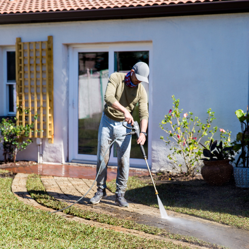 Powerwashing a sidewalk