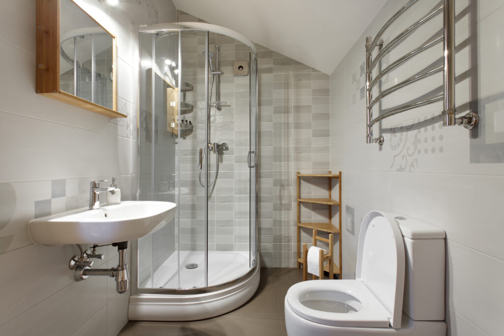 Small bathroom with toilet and shower in gray tones
