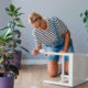 Woman at home painting a chair