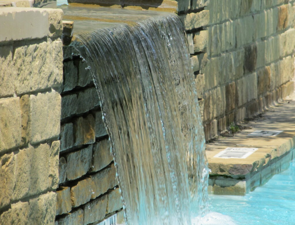 Pool waterfall features are attractive but will add significantly to the cost to build a pool.