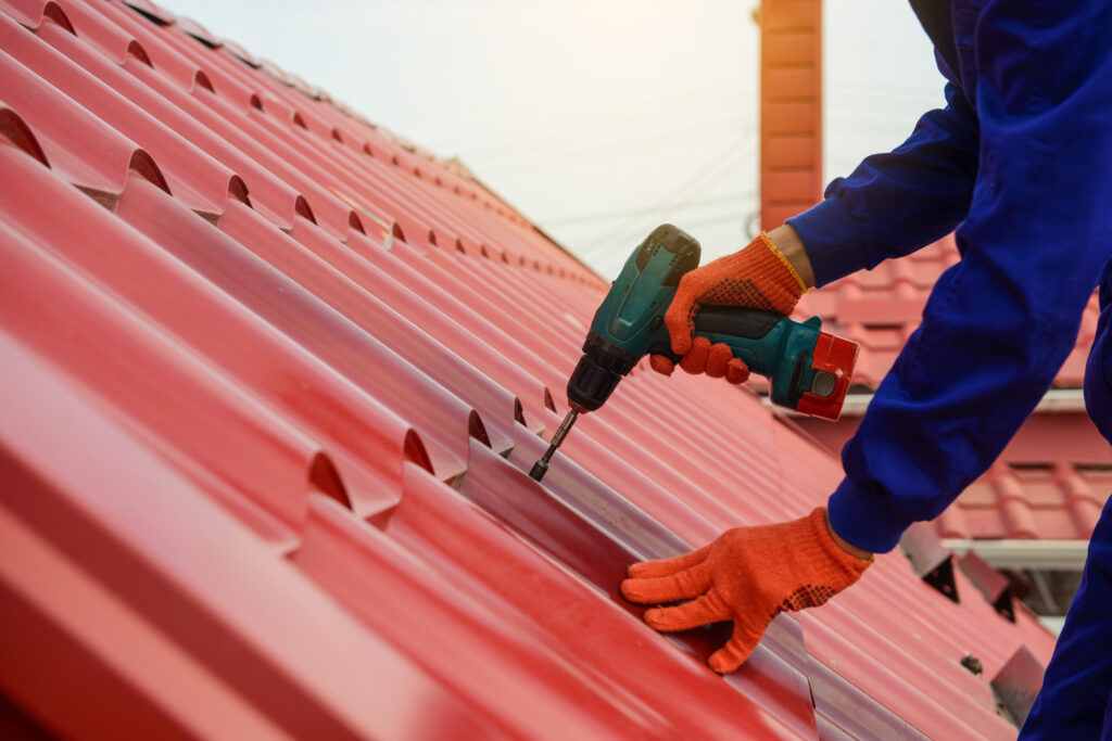 Contractor installing a metal roof.