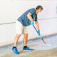 Man applying epoxy finish to concrete floor.